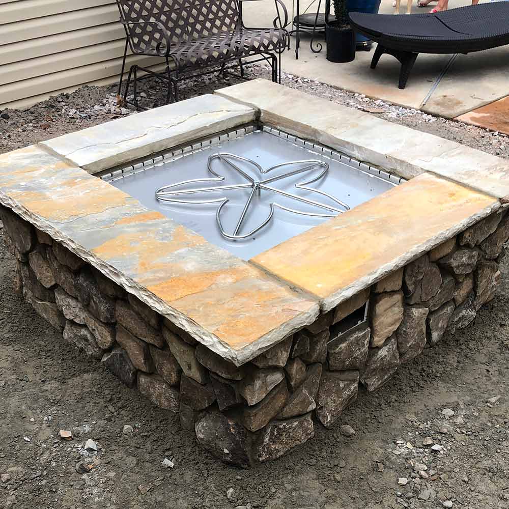 Penta burner installed in a custom stone gas fire pit